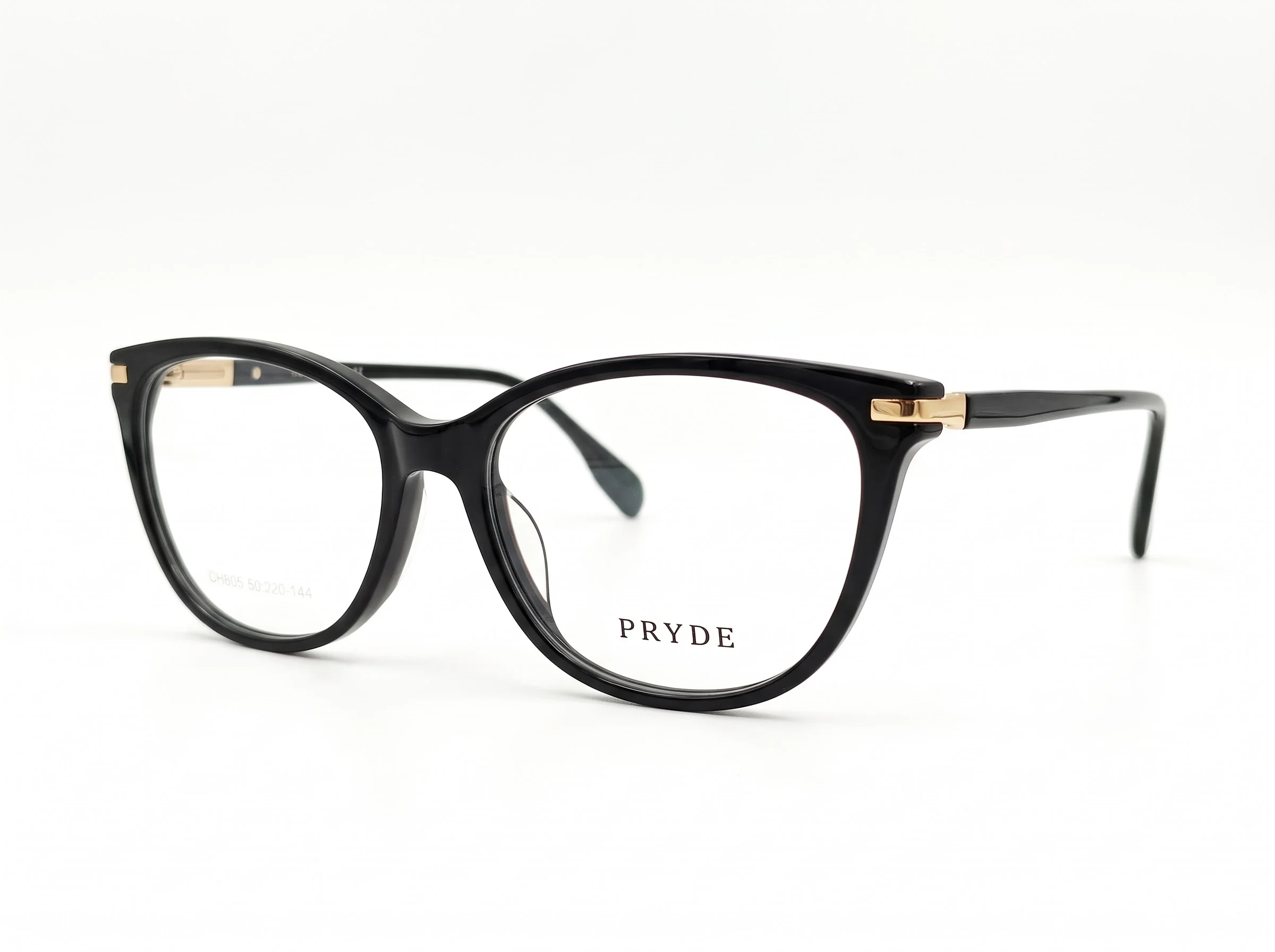 PRYDE NOIR OPTICAL — gloss black cat-eye optical frame with gold temple accents, three-quarter view on white background.